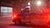 ambulance driving in the snow at night